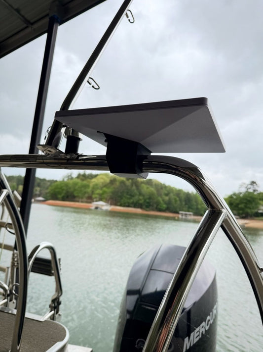 Starlink Mini on the rail mount clamped to a boat's polished stern rail over the water, outboard motor behind