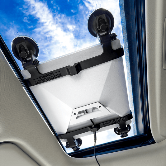 Starlink Mini suction cup mount seen from inside the cabin, four locking suction cups holding the dish against the sunroof glass