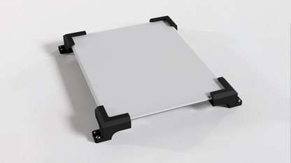 Angled view of a Starlink V5 dish lying face up in the roof mount's four corner brackets